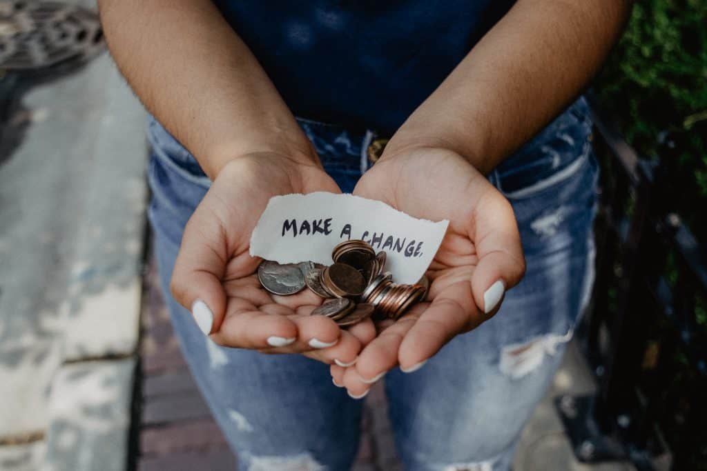 This is an image of a woman with change in her hands.